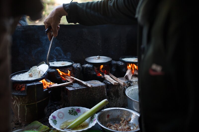 Person Cooking over Fire
