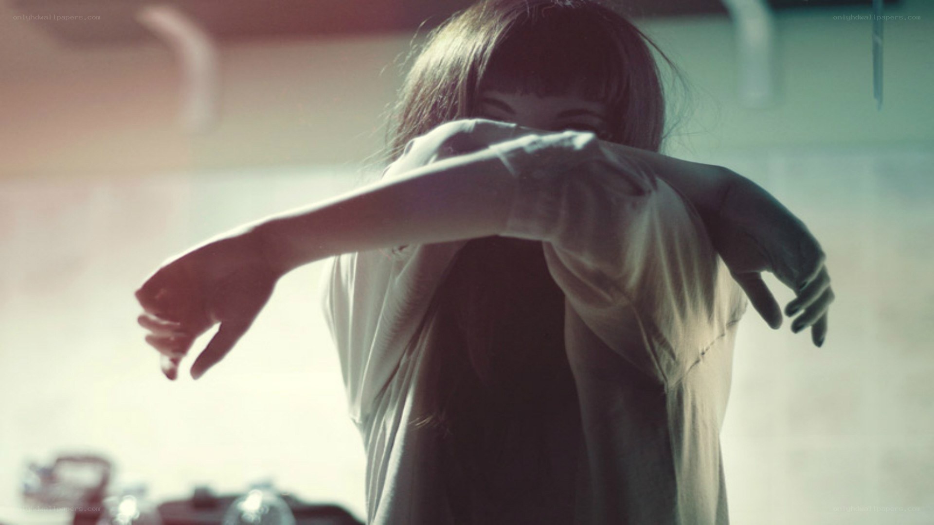 person covering face with arms