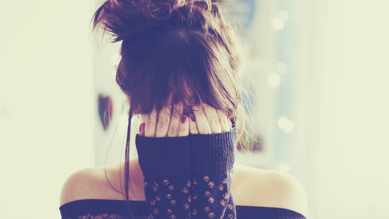 person covering face with hands