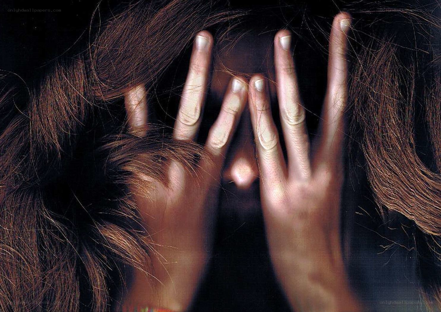 Person covering face with hands