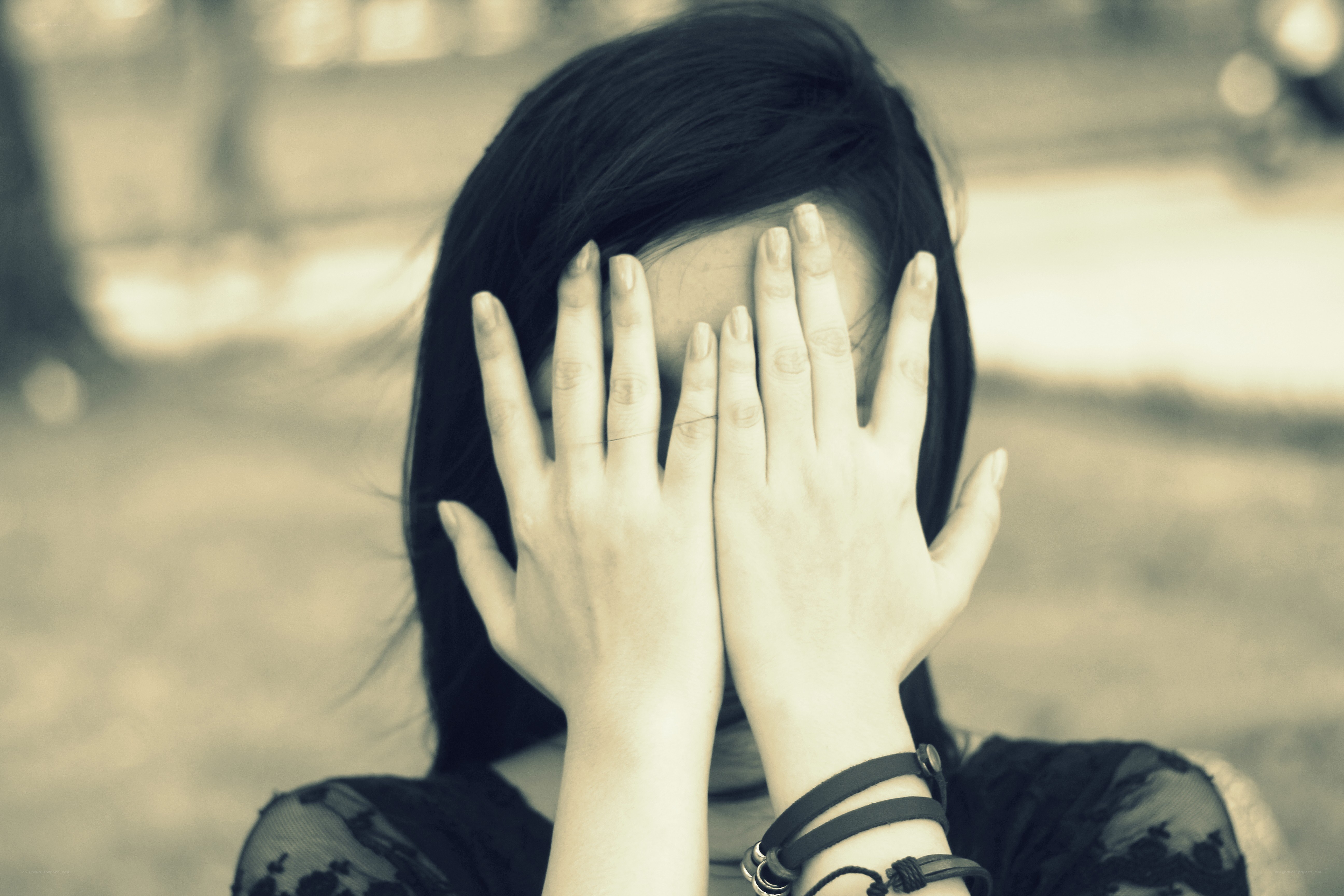 person covering face with hands