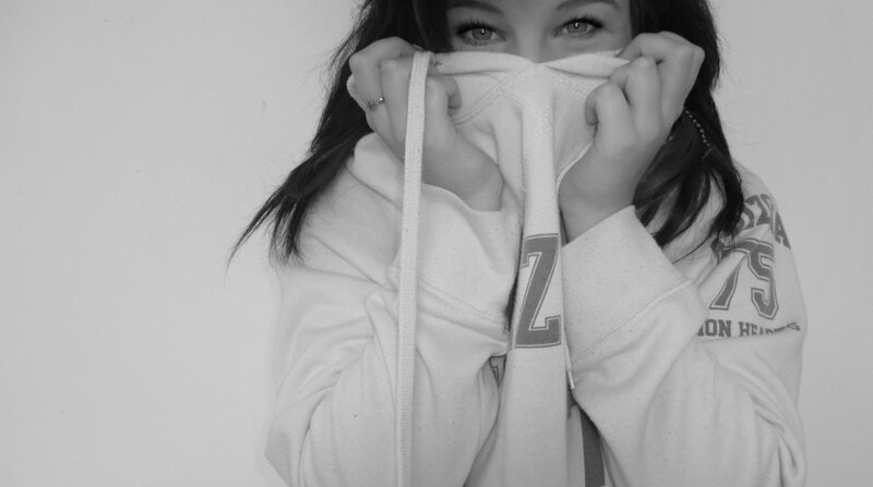 person covering face with hoodie