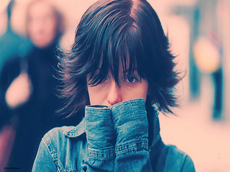 person covering mouth with jacket