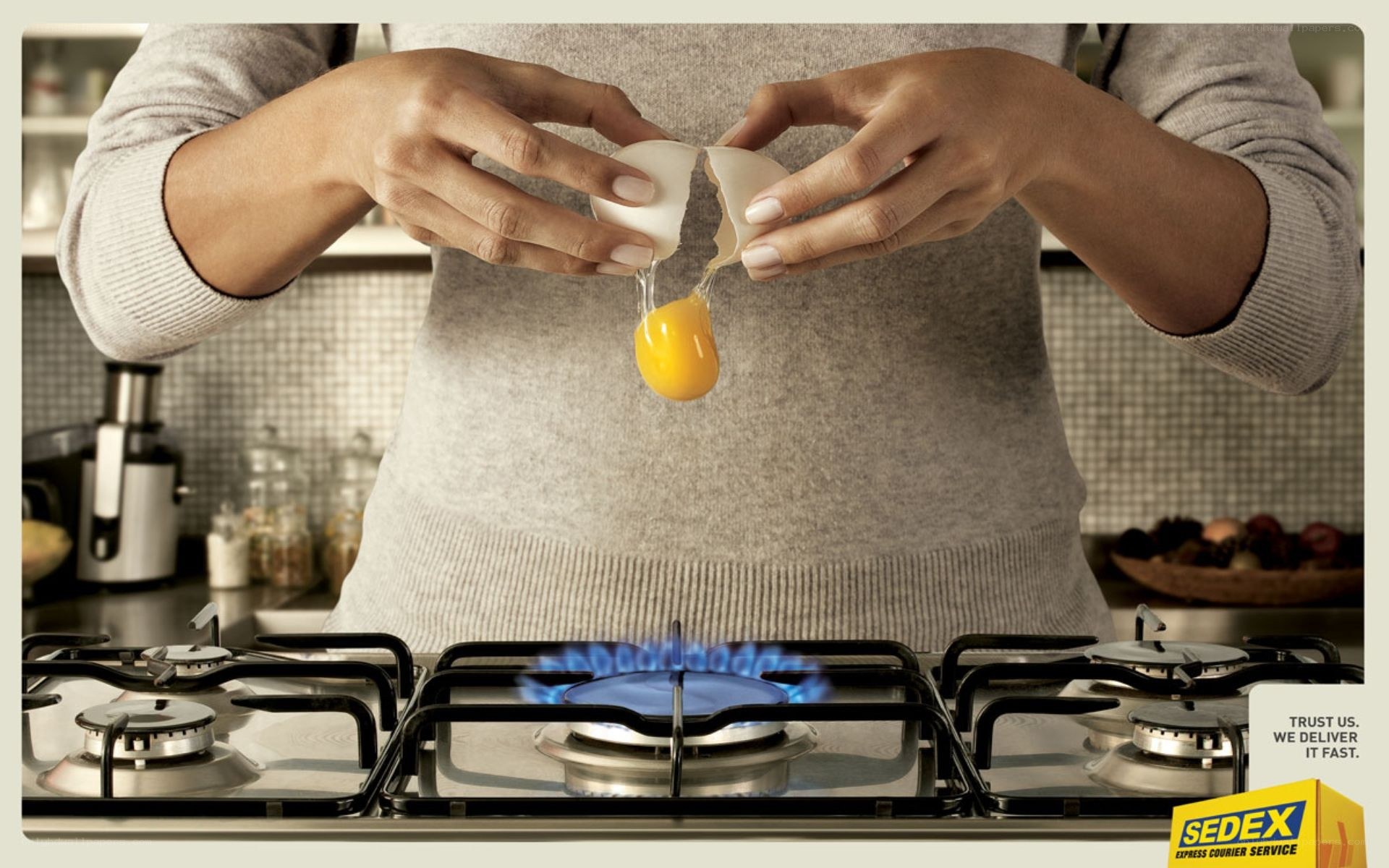 person cracking egg over stove