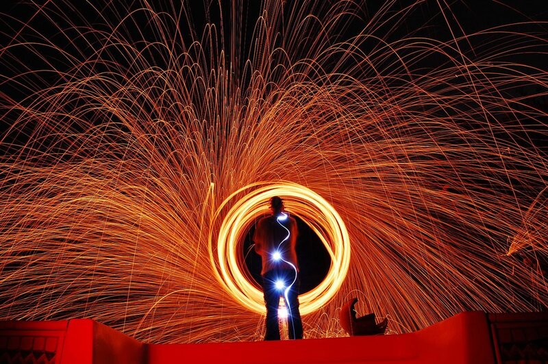 Person creating light art with sparks