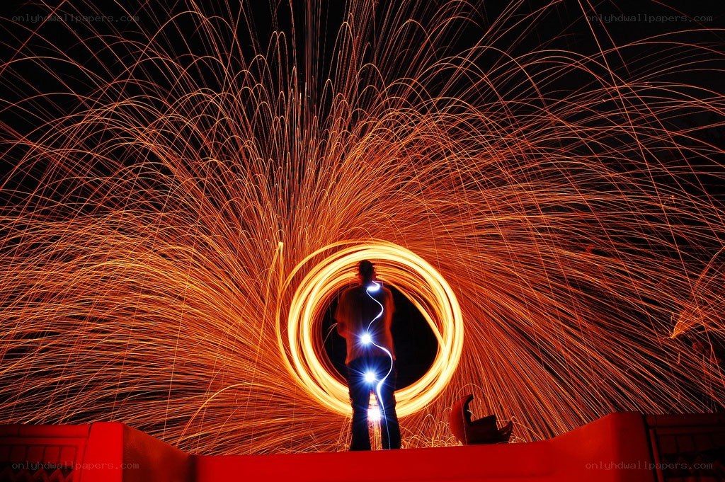 Person creating light art with sparks