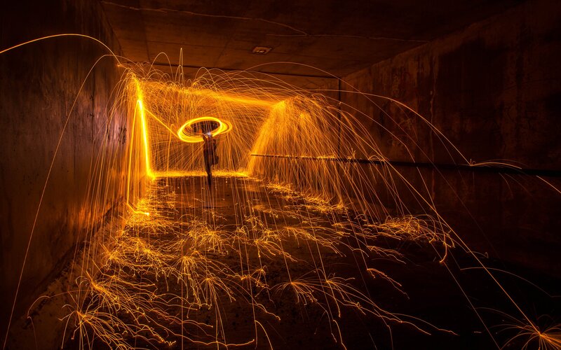 Person Creating Light Trails — Orange, Dramatic