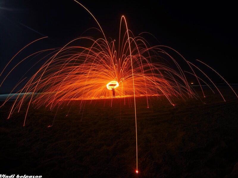 Person Creating Spark Art — Orange