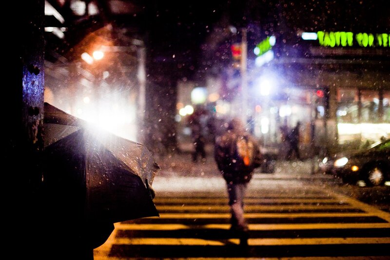 Person crossing street in rain