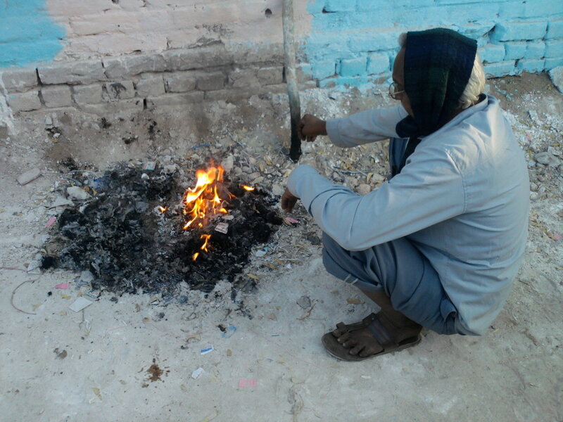 Person Crouching by Fire