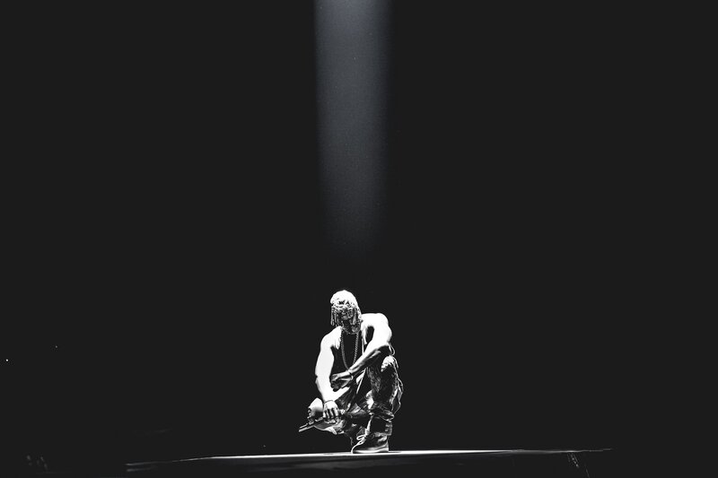 Person Crouching on Stage