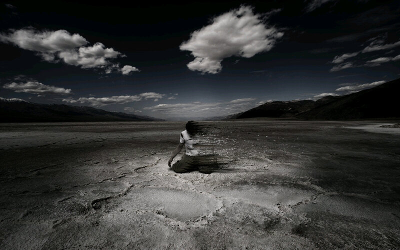 Person dissolving in desert