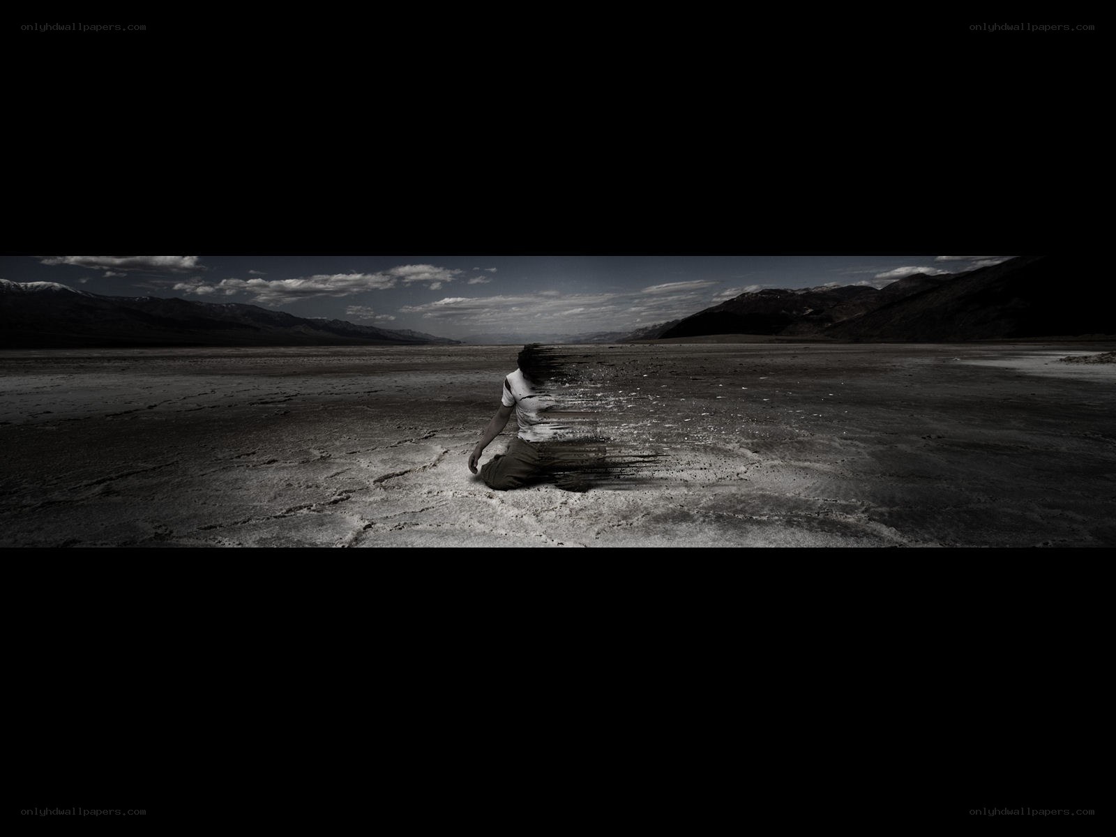 person dissolving in desert