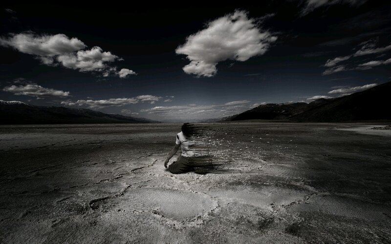 person dissolving in desert
