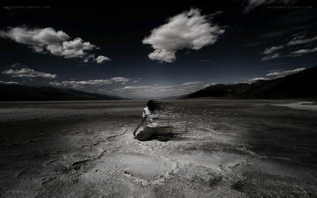 person dissolving in desert