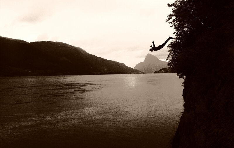 person diving into a lake