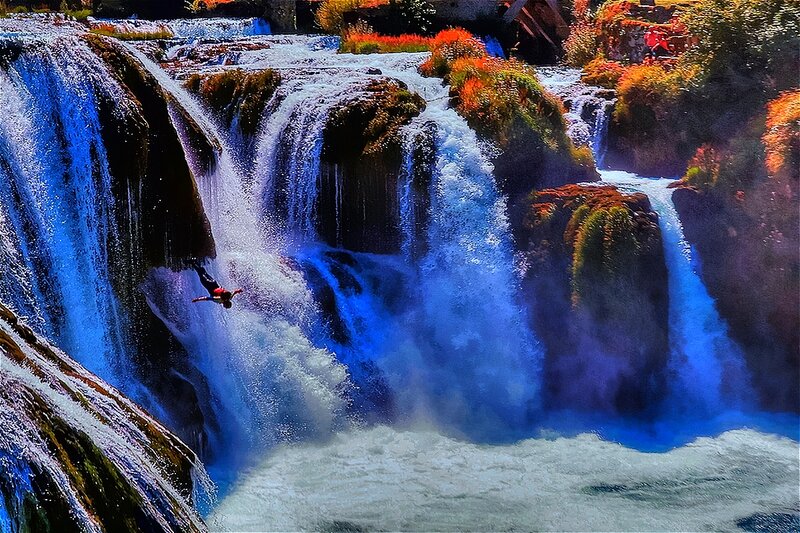 Person Diving into Waterfall