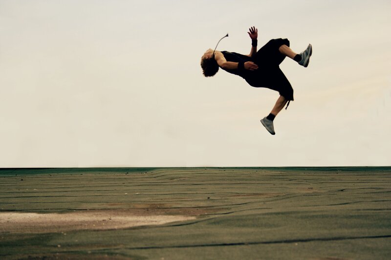 Person Doing Backflip — Gray