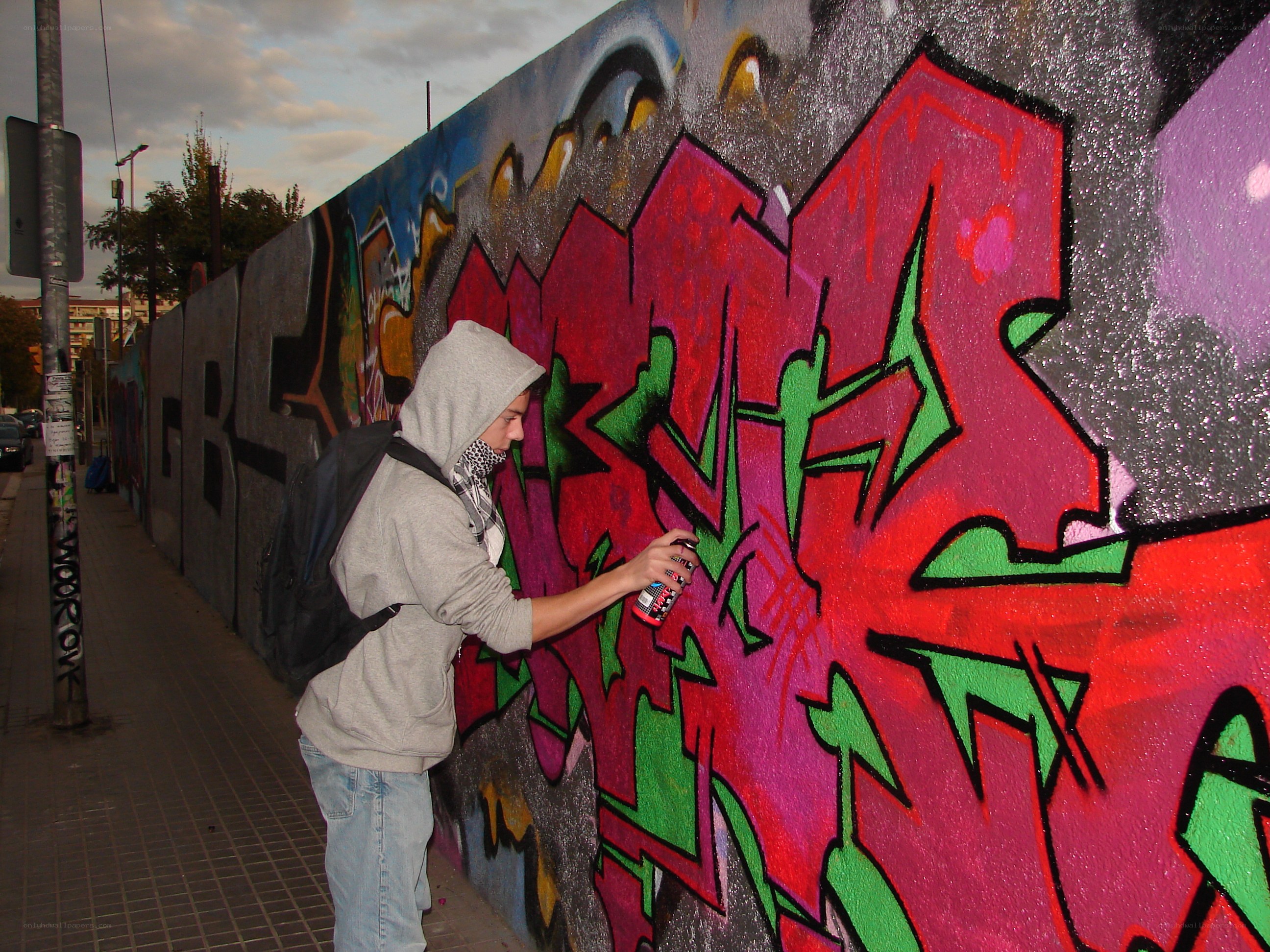 person doing graffiti on wall