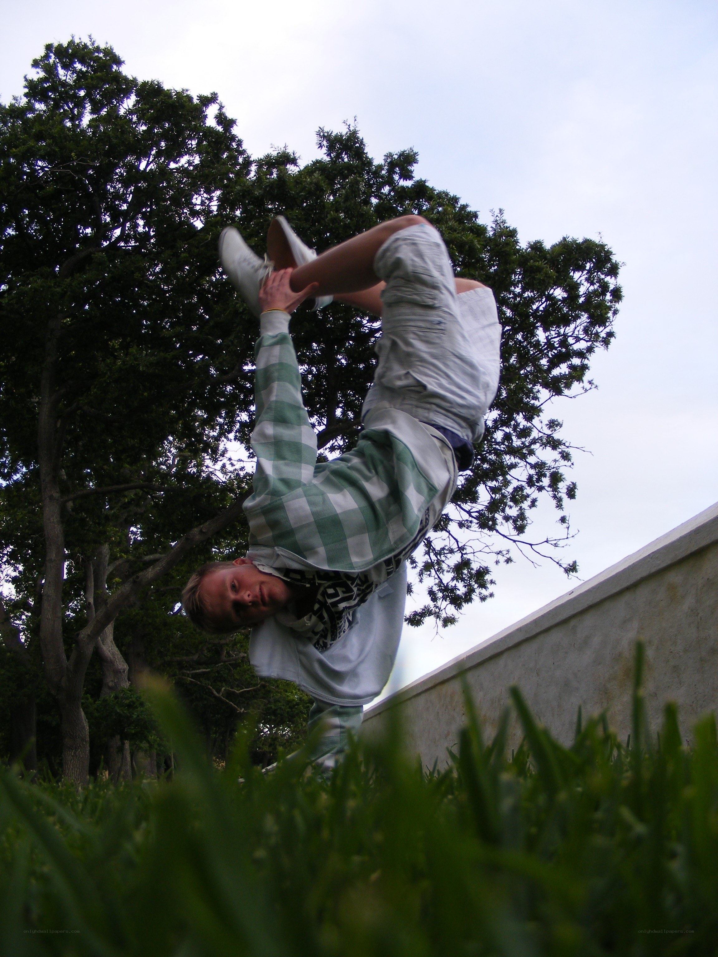 person doing handstand in park