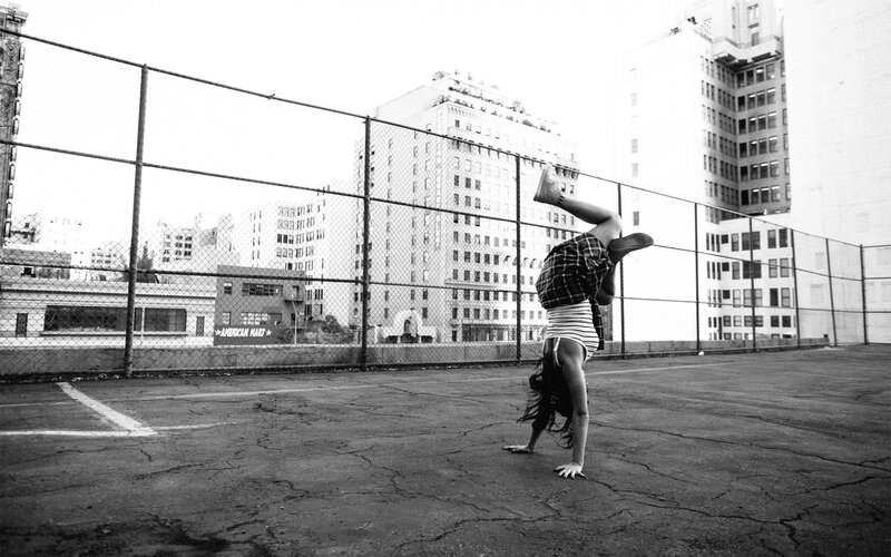 Person doing handstand in parking lot