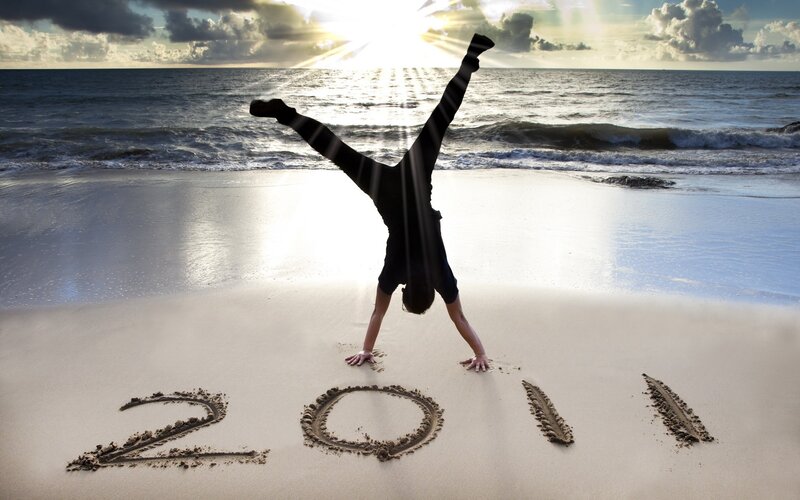 Person doing handstand on beach