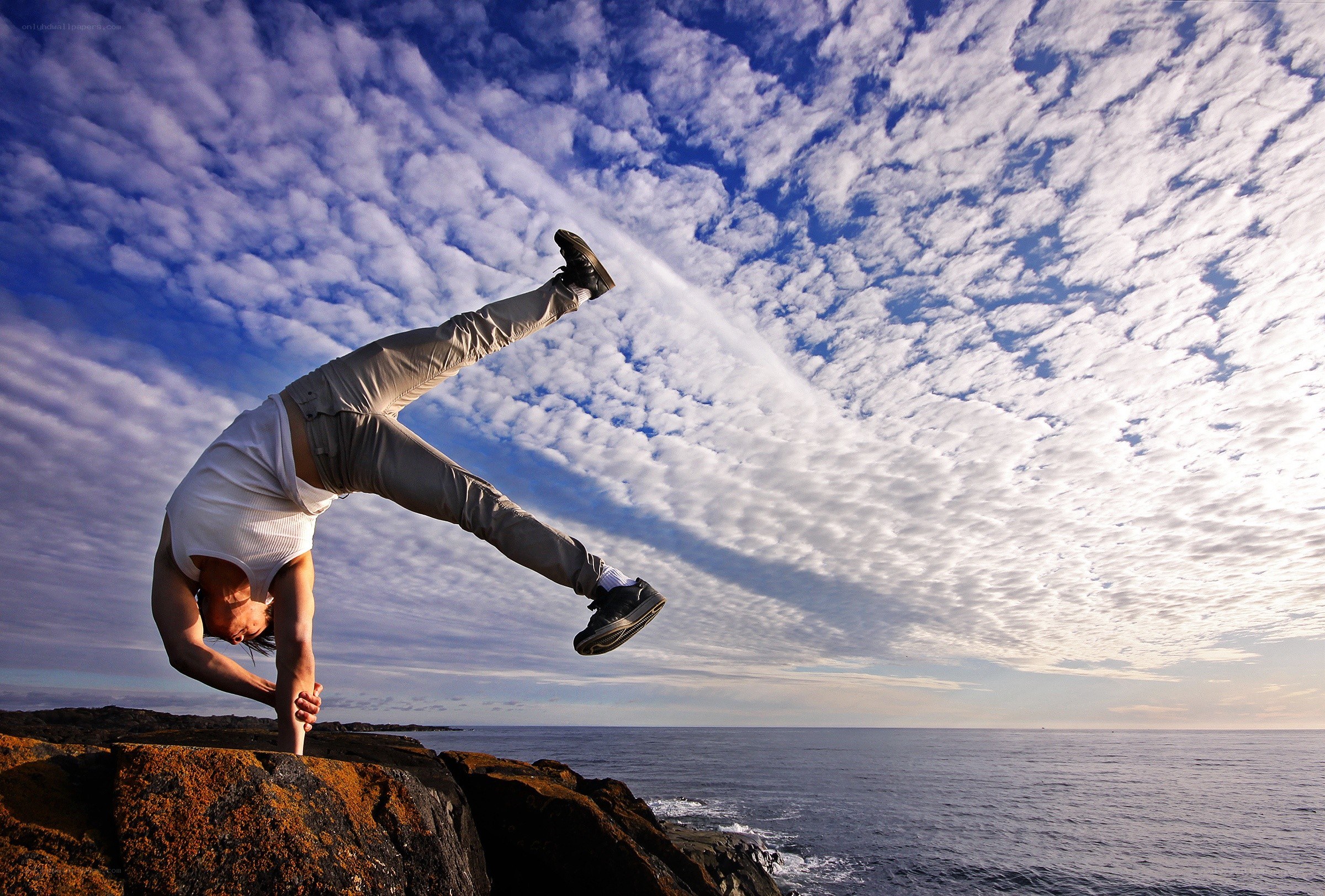 Person doing handstand on rocks