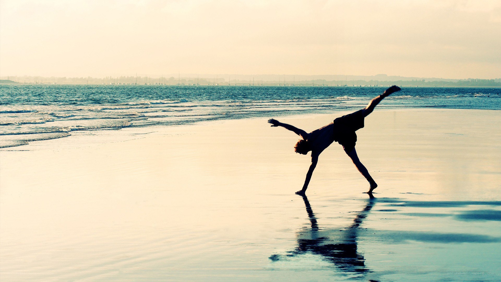 person doing yoga on beach