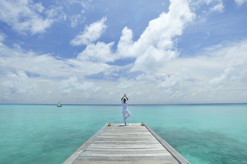 Person Doing Yoga on Dock — Blue
