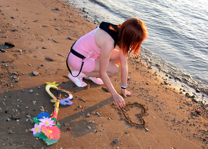 Person Drawing Heart in Sand