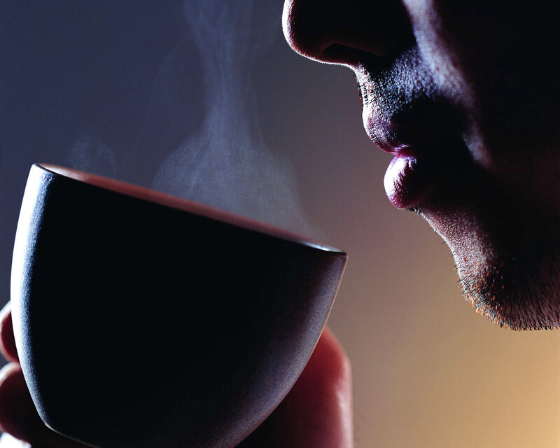 person drinking from a cup