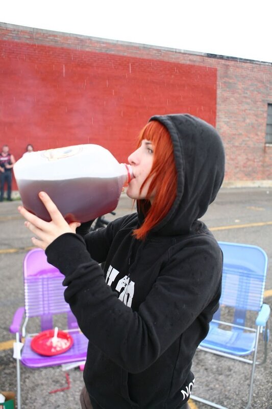 person drinking from a jug