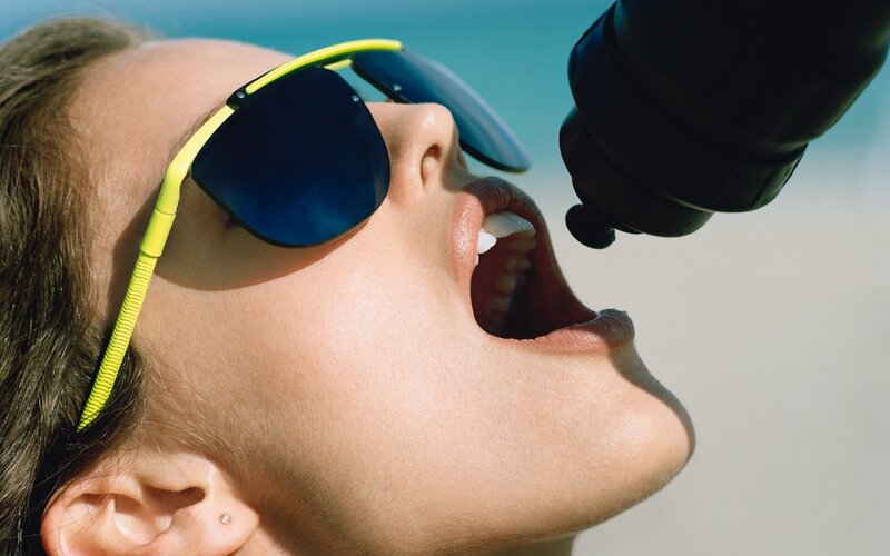 person drinking from bottle