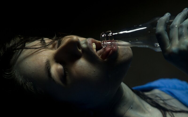 person drinking from bottle