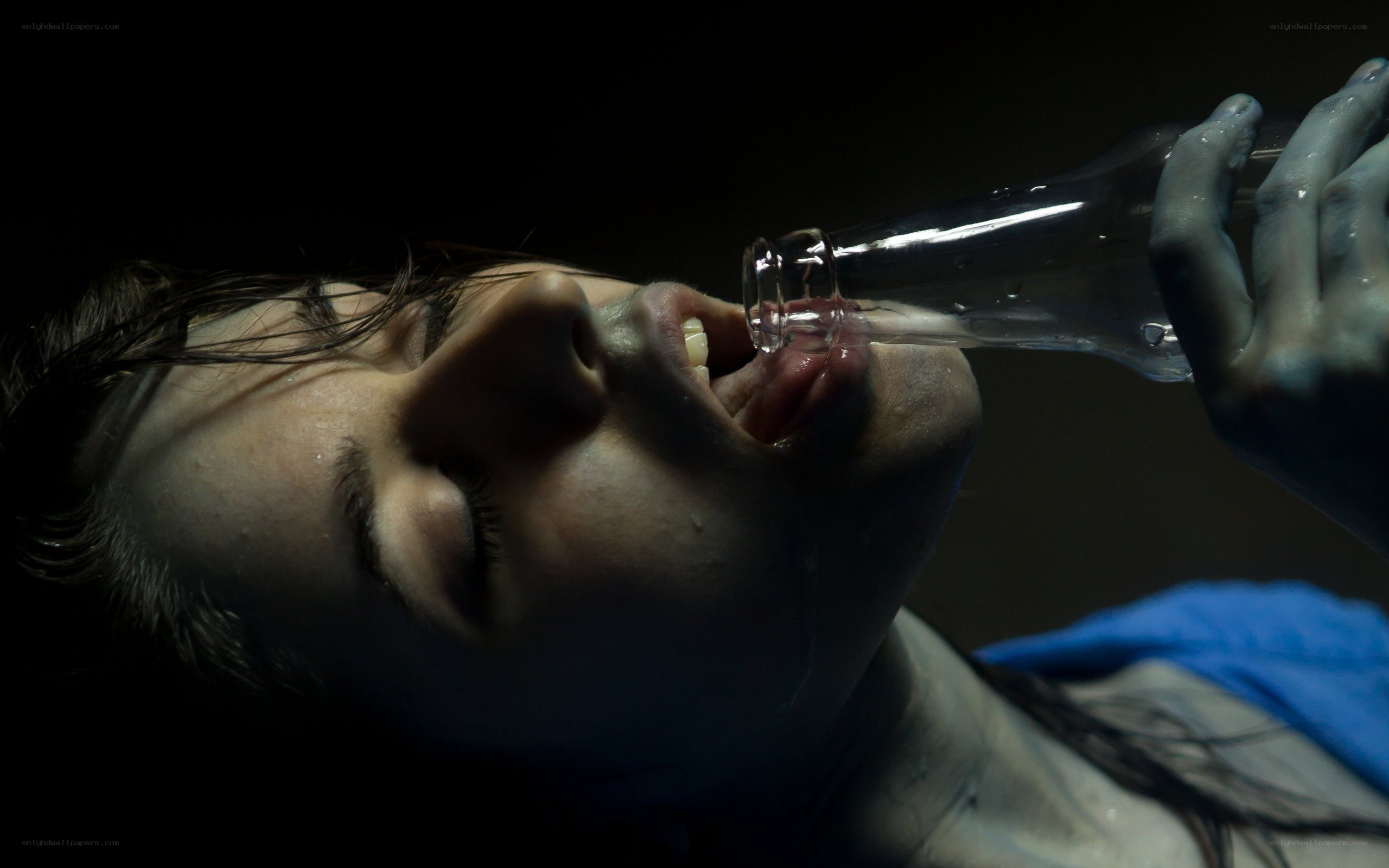 person drinking from bottle