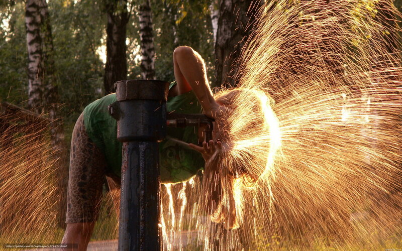 Person drinking from water spout