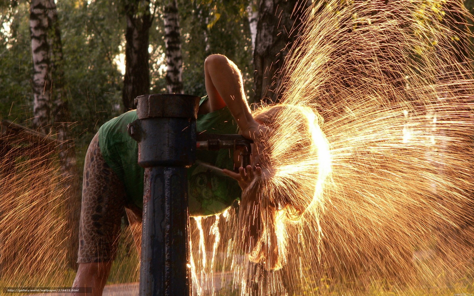 Person drinking from water spout