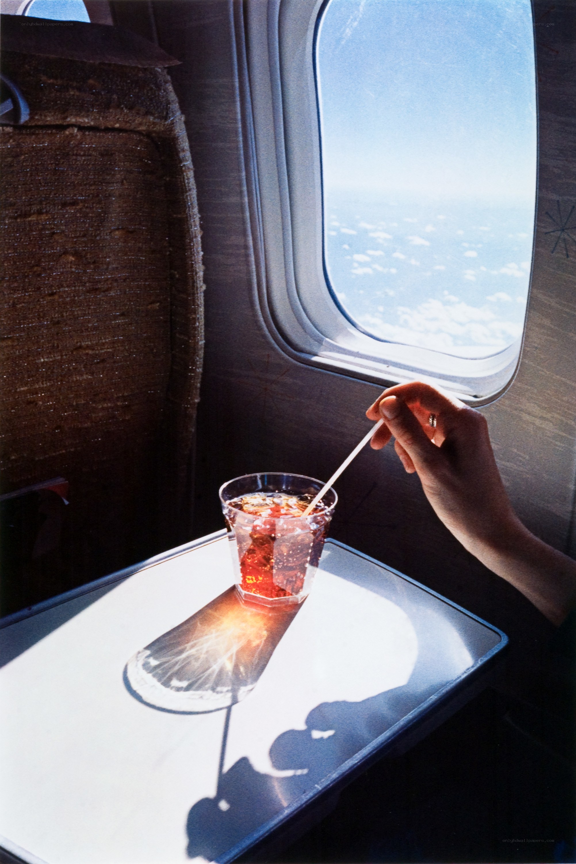 Person drinking on an airplane