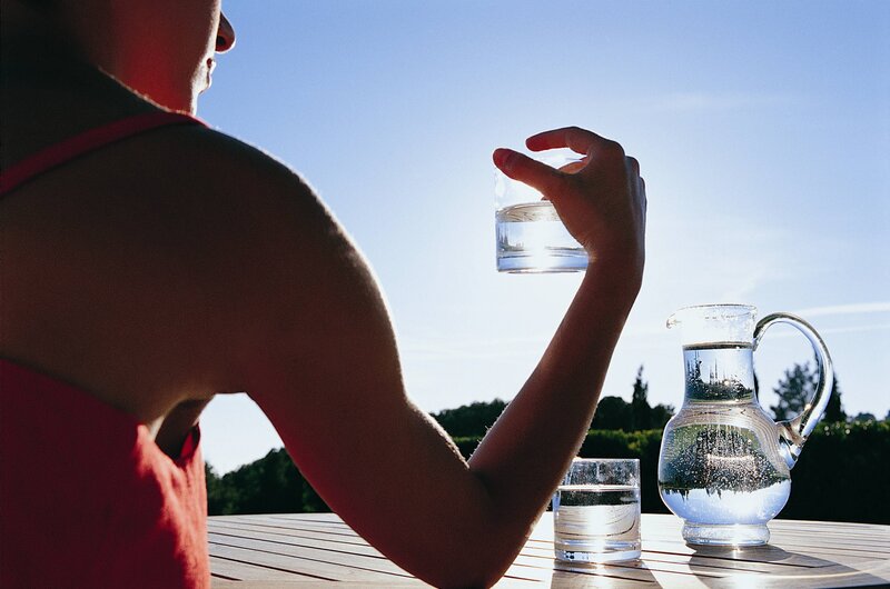 Person drinking water outdoors