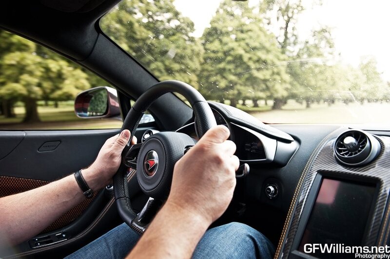 person driving a sports car
