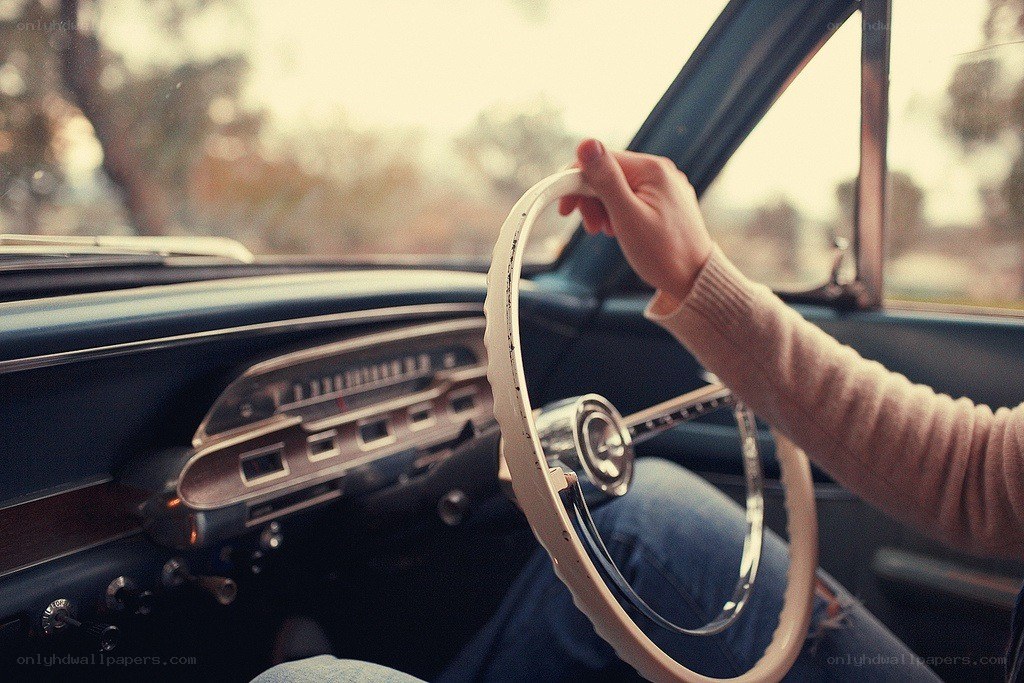 person driving a vintage car