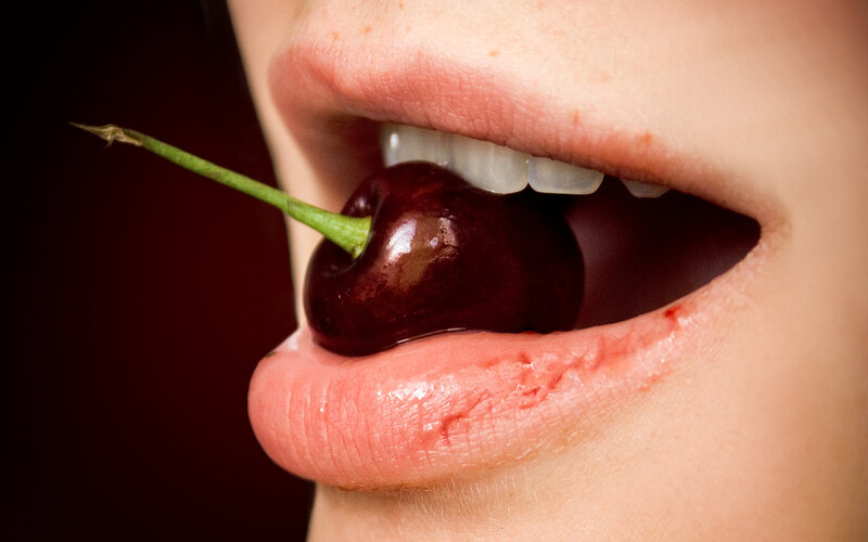 person eating a cherry