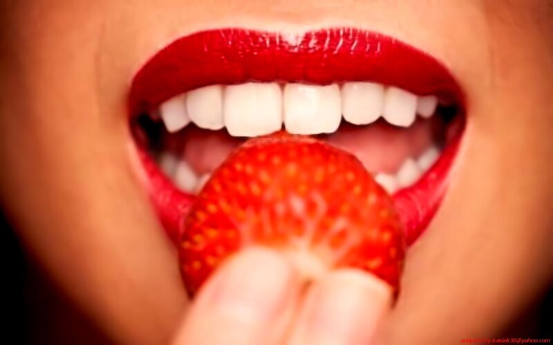 person eating a strawberry