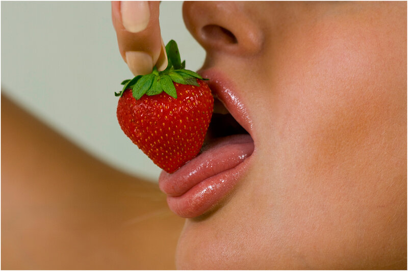 person eating a strawberry