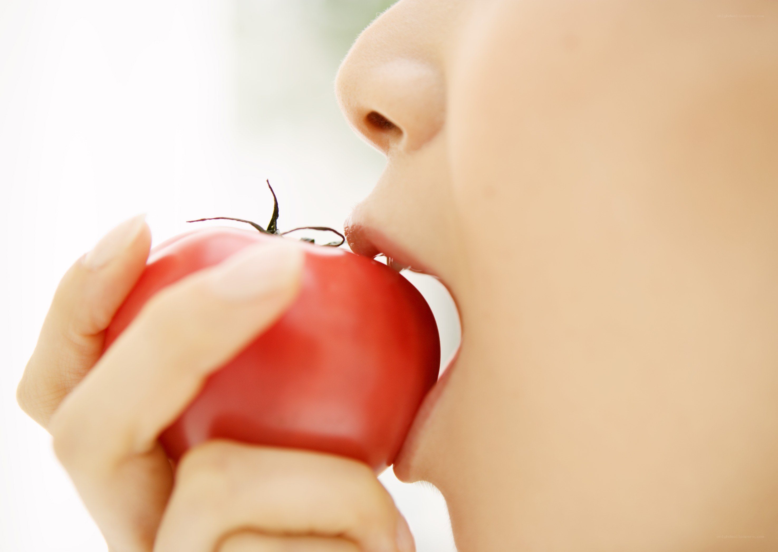 person eating a tomato