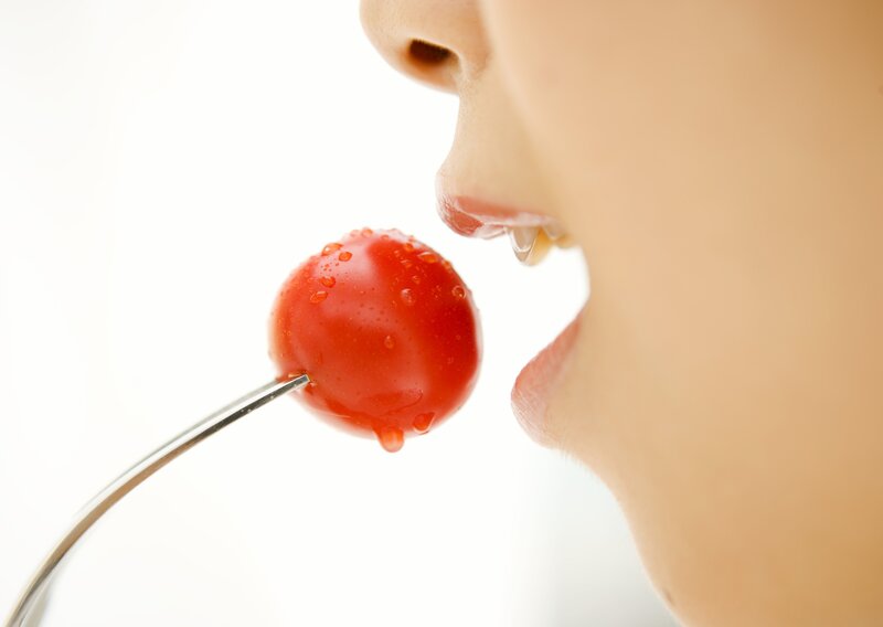 person eating cherry tomato