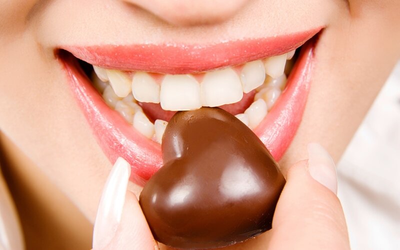 person eating chocolate heart