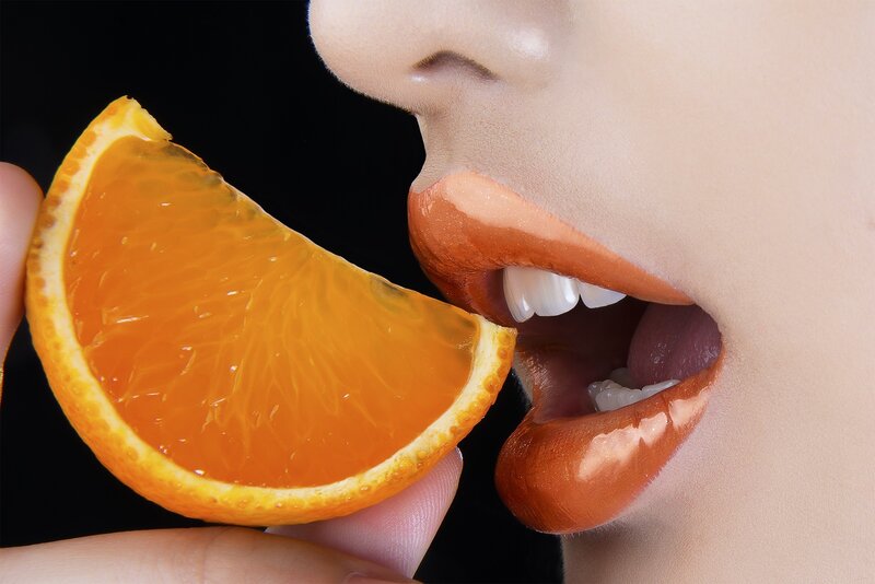 Person Eating Orange Slice