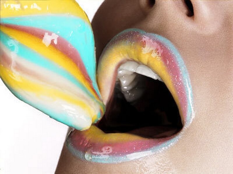 Person Eating Rainbow Lollipop