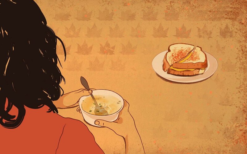 person eating soup and sandwich